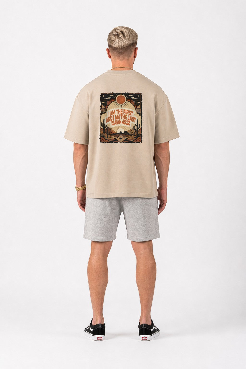 Reyes & Company oversized beige t-shirt with Isaiah 48:12 desert graphic print on back worn by a man from behind